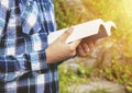 Man reading a book in the park. Student studying memorizing notes outdoors.