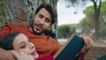 Man reading book picnic for relaxed woman close up. Romantic couple in park. Royalty Free Stock Photo