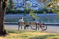 Man reading a book sitting on a bench at seaside in Vancouver Royalty Free Stock Photo