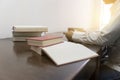 man reading book with textbook stack on wooden desk Royalty Free Stock Photo