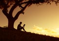 Man reading a book under tree. Royalty Free Stock Photo