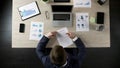 Man reading business contract, concluding agreement with partner, top view