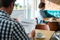 Man reading a business newspaper in coffee shop Royalty Free Stock Photo