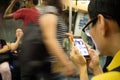 Man reading on cellphone on subway