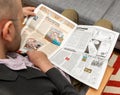 Man reading Charlie Hebdo our solitude article