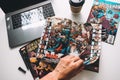 Man reading comic books on the white table in between work