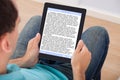 Man reading ebook at home Royalty Free Stock Photo