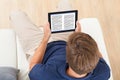 Man reading ebook at home Royalty Free Stock Photo