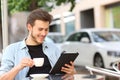 Man reading an ebook or tablet in a coffee shop Royalty Free Stock Photo