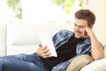 Man reading an ebook or tablet at home Royalty Free Stock Photo