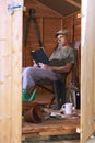 Man reading in garden shed Royalty Free Stock Photo