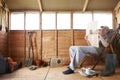 Man reading in garden shed Royalty Free Stock Photo