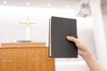 A man is reading the Holy Bible and praying in a worship room in a Christian church Royalty Free Stock Photo