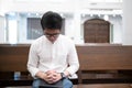 A man is reading the Holy Bible and praying in a worship room in a Christian church Royalty Free Stock Photo