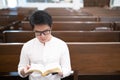 A man is reading the Holy Bible and praying in a worship room in a Christian church Royalty Free Stock Photo