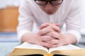 A man is reading the Holy Bible and praying in a worship room in a Christian church Royalty Free Stock Photo