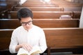 A man is reading the Holy Bible and praying in a worship room in a Christian church Royalty Free Stock Photo