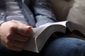 Man reading holy Bible on sofa, closeup Royalty Free Stock Photo