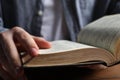 Man reading holy Bible at wooden table, closeup Royalty Free Stock Photo