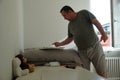 A man reading instructions for DIY assembly of a computer or office desk for his son. The set of furniture was ordered online and Royalty Free Stock Photo