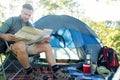 Man reading the map outside the tent Royalty Free Stock Photo