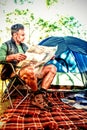 Man reading the map outside the tent Royalty Free Stock Photo