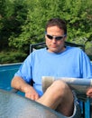 Man reading near a pool Royalty Free Stock Photo