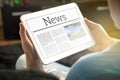 Man reading the news on tablet at home. Royalty Free Stock Photo