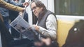 Man reading newspaper in the metro train Royalty Free Stock Photo
