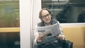 Man reading newspaper in the metro train Royalty Free Stock Photo