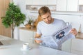 man reading newspaper during morning time at kitchen table with coffee