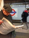 Man reading a newspaper on a train