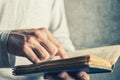 Man reading old book with torn pages Royalty Free Stock Photo