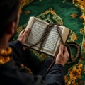 Man Reading Book with Rosary Beads on Decorated Rug Royalty Free Stock Photo
