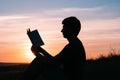 Man reading in the park against sunset Royalty Free Stock Photo
