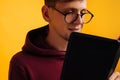 Man is reading and studying the Bible, the man is holding the Bible in his hands. Bible reading over yellow background Royalty Free Stock Photo