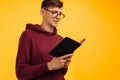 Man is reading and studying the Bible, the man is holding the Bible in his hands. Bible reading over yellow background Royalty Free Stock Photo