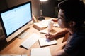 Man reading and writing using information from computer Royalty Free Stock Photo