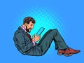 A man reads an electronic tablet