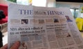 A man reads the Indian newspaper The Hindu in the hotel lobby, Delhi