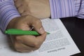 A man reads a model release before signing it. Royalty Free Stock Photo