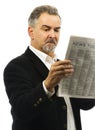Man reads newspaper with serious look on face