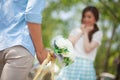 Man ready to give flowers to girlfriend