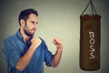 Man ready to punch boxing bag with boss written on it. Employee employer relationship concept Royalty Free Stock Photo