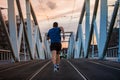 Man rear view running fast along bridge