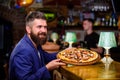 Man received delicious pizza. Enjoy your meal. Cheat meal concept. Hipster hungry eat italian pizza. Pizza favorite Royalty Free Stock Photo