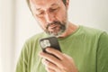 Man received satisfying text message or e-mail on smartphone Royalty Free Stock Photo
