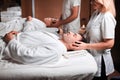 Man receiving back massage from masseur in spa Royalty Free Stock Photo