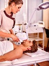 Man receiving darsonval facial massage Royalty Free Stock Photo