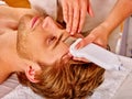 Man receiving electric facial peeling massage